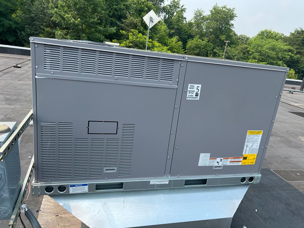 A freshly installed packaged HVAC unit on a rooftop